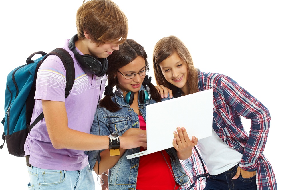 Three teenagers studying with laptop